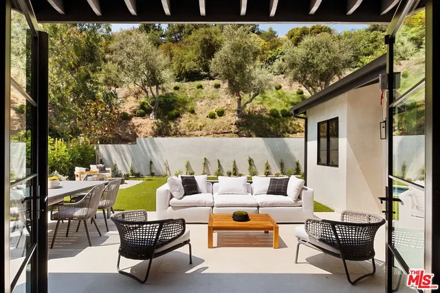 a view of a patio with swimming pool and sitting area
