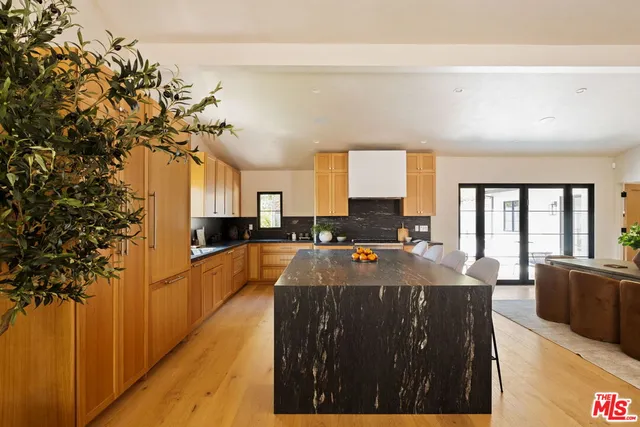 a bedroom with a bed and a flat tv screen on wall