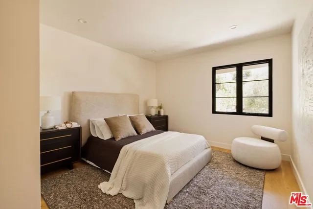a bathroom with a sink and mirror with shower