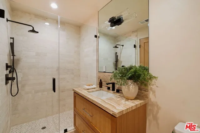 a bathroom with a sink a faucet and a mirror