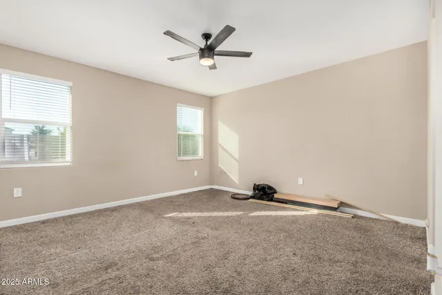 a view of a livingroom with a ceiling fan and window