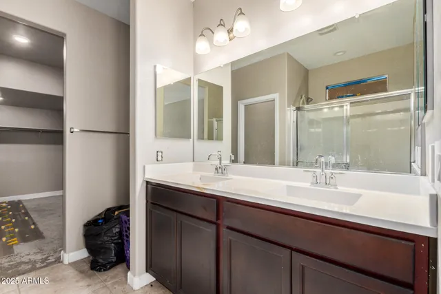 a bathroom with a sink double vanity and a mirror