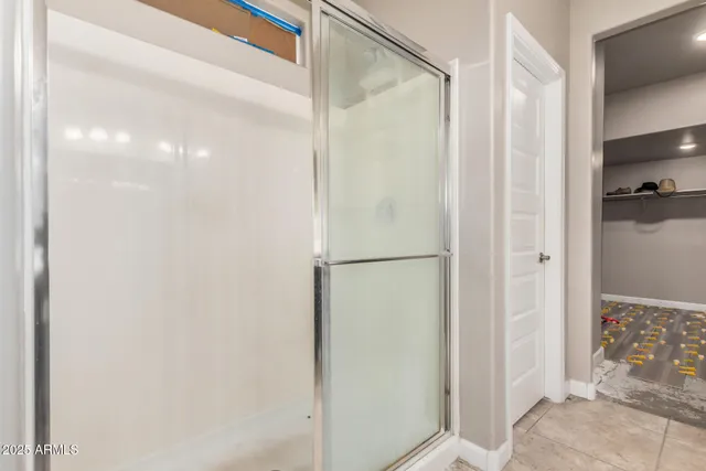 a bathroom with a glass shower door