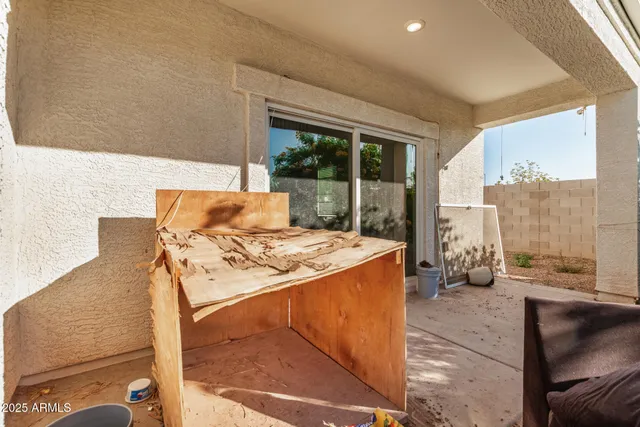 a bedroom with furniture and large windows