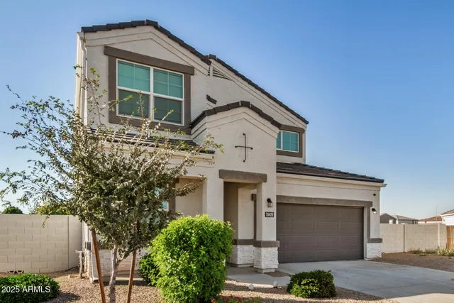 a front view of a house with plants