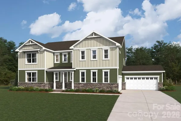 a front view of a house with a garden and yard