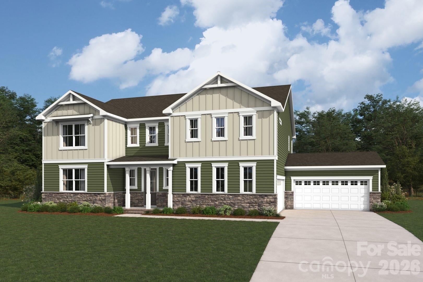 a front view of a house with a garden and yard