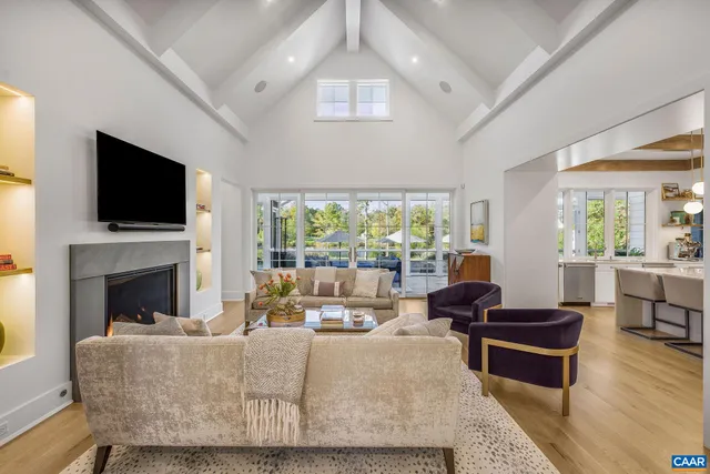 a living room with fireplace furniture and a flat screen tv