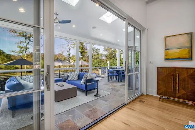 a living room with furniture wooden floor and a table