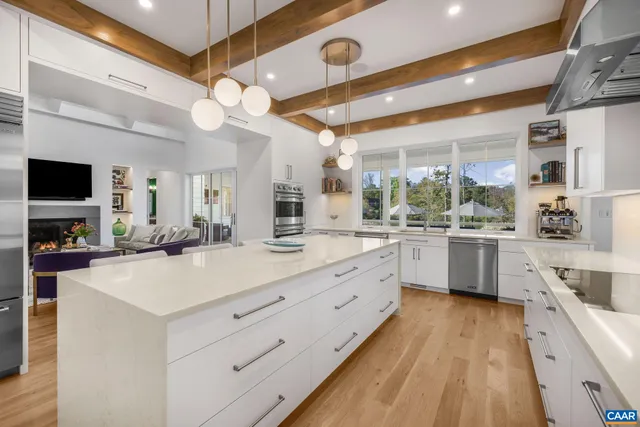 a view of a dining room with furniture a chandelier and wooden floor