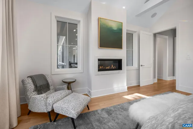 a spacious bedroom with a bed and a chandelier