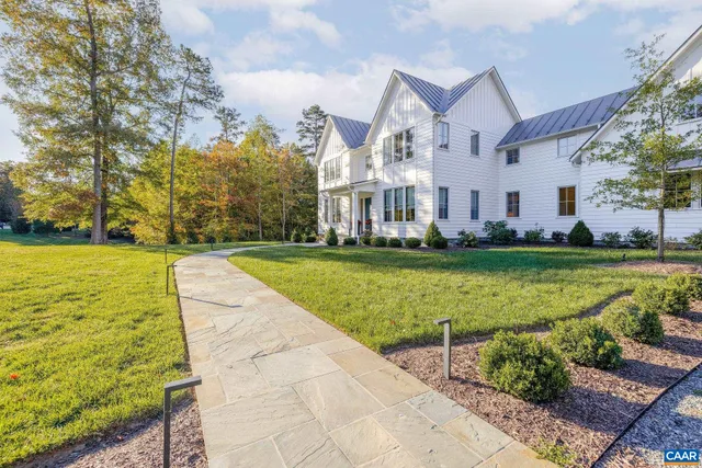 a front view of a house with outdoor seating