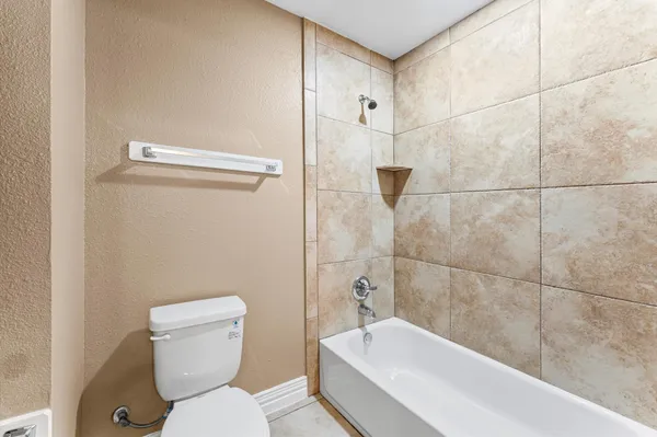 a bathroom with a toilet and shower