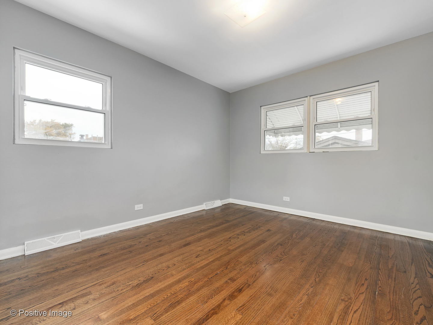 7505 East Prairie Road Skokie, IL 60076 - Photo 14 of 23 a view of an empty room with wooden floor and a window