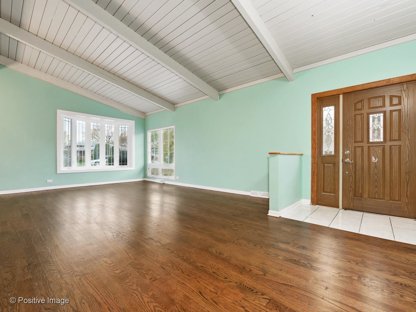 7505 East Prairie Road Skokie, IL 60076 - Photo 3 of 23 a view of an empty room with window and wooden floor