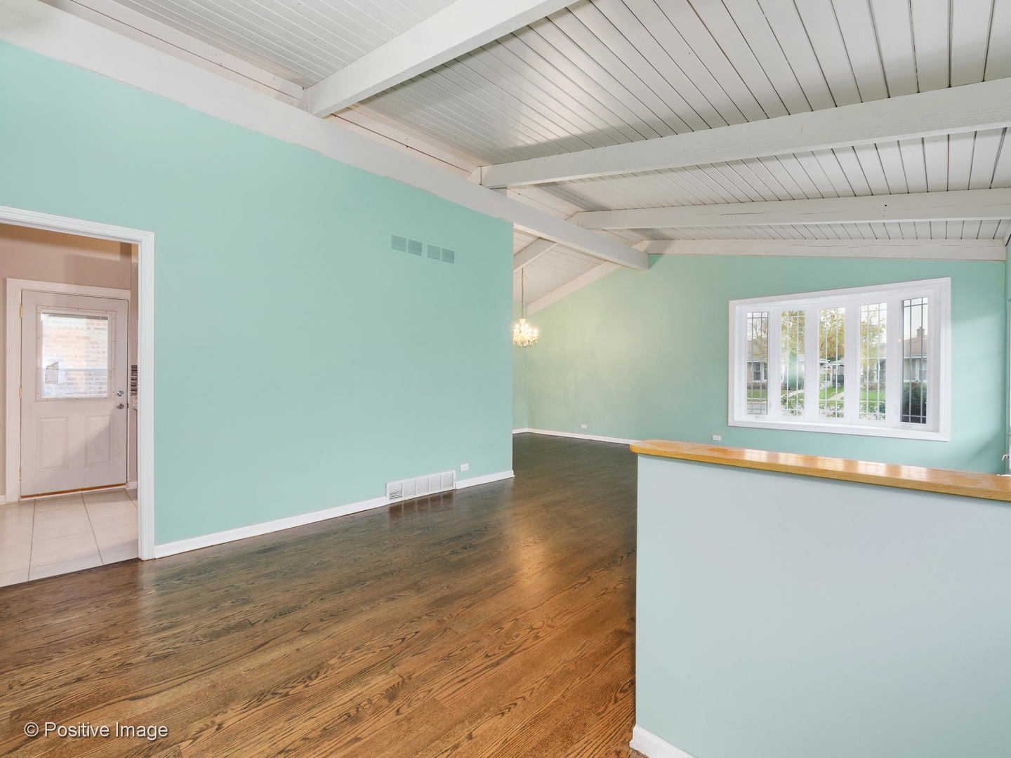 7505 East Prairie Road Skokie, IL 60076 - Photo 4 of 23 an empty room with wooden floor and windows