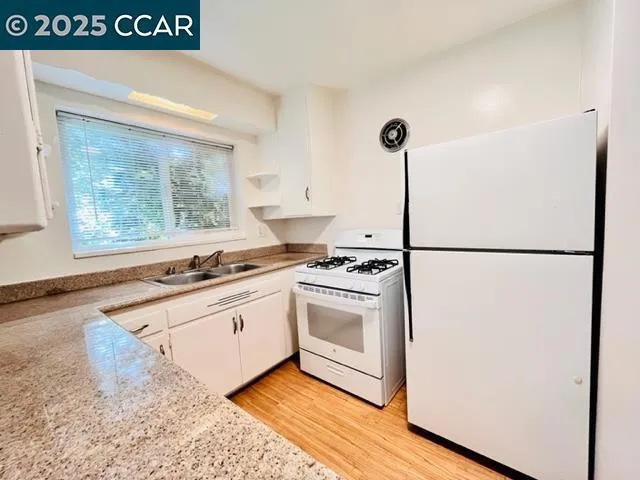 a kitchen with a stove a sink and a refrigerator