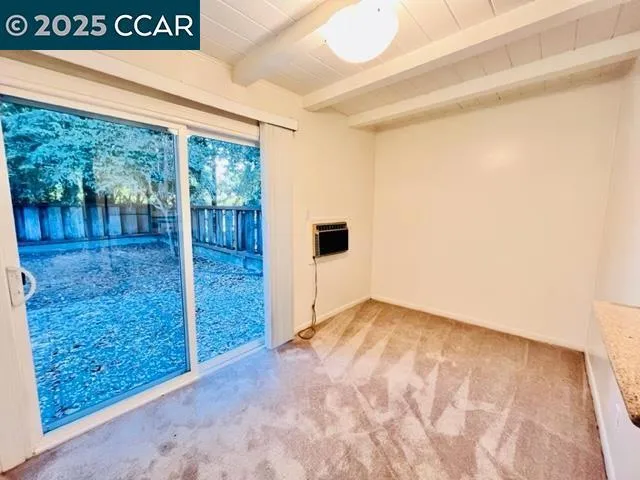 a view of a big room with wooden floor and windows