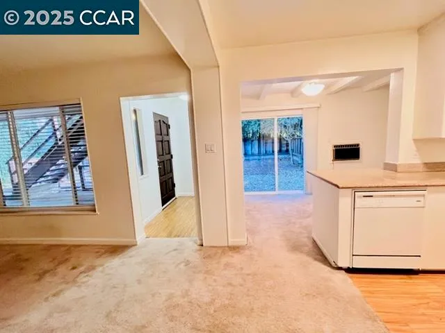 a view of an empty room and a window