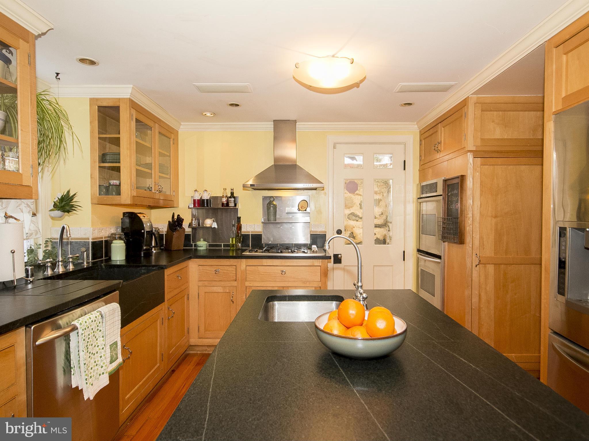 2539 Pickwick Road Baltimore, MD 21207 - Photo 11 of 30 a large kitchen with stainless steel appliances kitchen island granite countertop a sink and cabinets