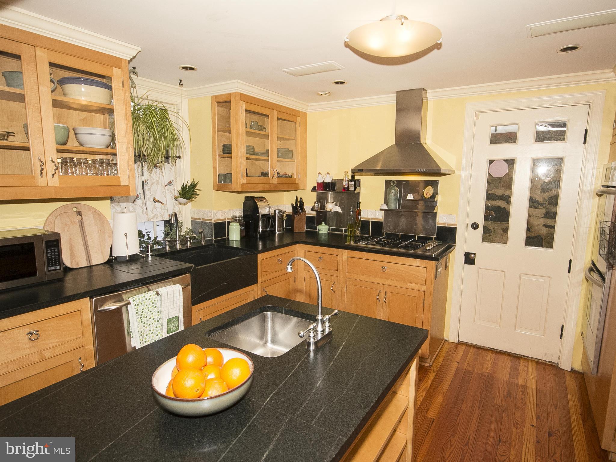 2539 Pickwick Road Baltimore, MD 21207 - Photo 12 of 30 a kitchen with granite countertop a stove and white cabinets
