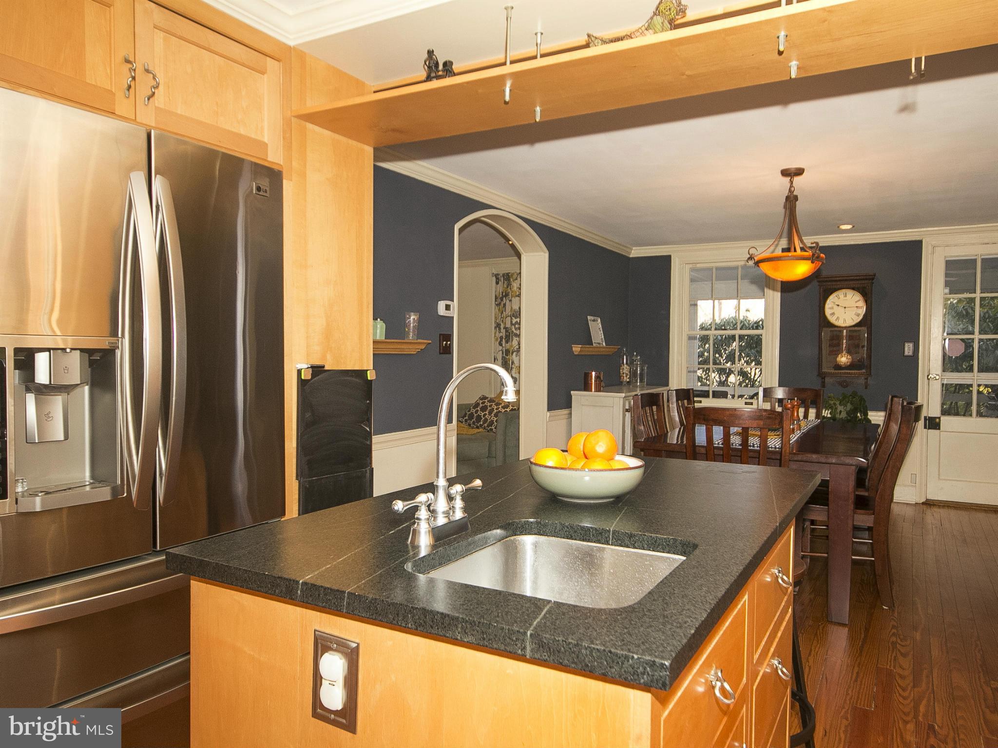 2539 Pickwick Road Baltimore, MD 21207 - Photo 13 of 30 a kitchen with granite countertop a sink a counter top space and living room view