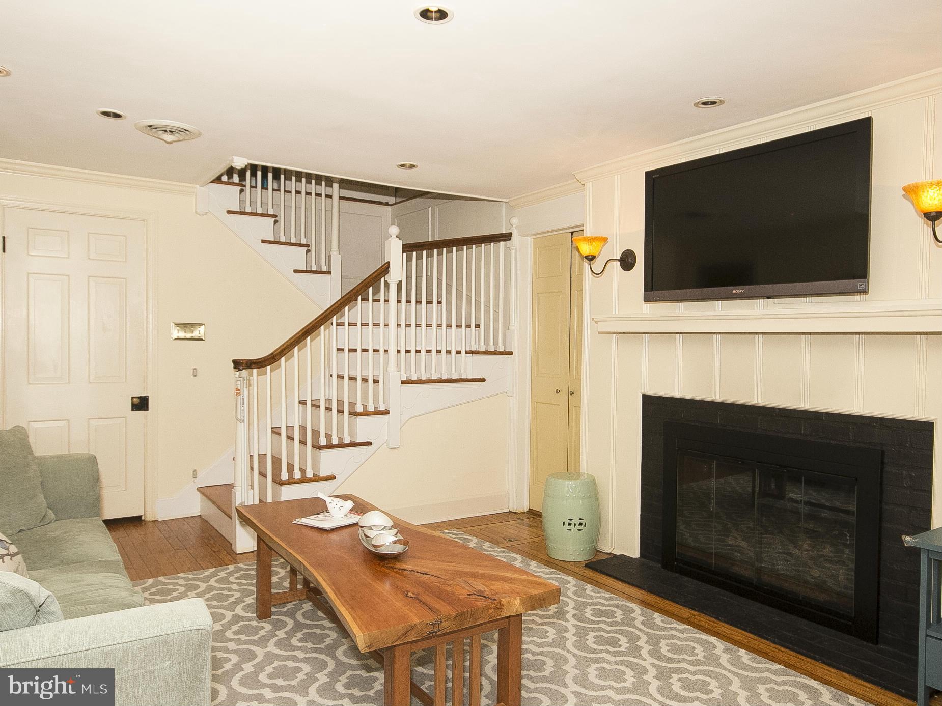 2539 Pickwick Road Baltimore, MD 21207 - Photo 15 of 30 a living room with furniture a flat screen tv and a fireplace