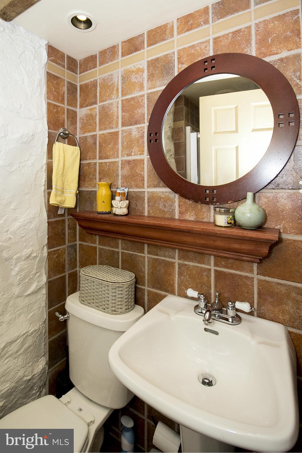 2539 Pickwick Road Baltimore, MD 21207 - Photo 16 of 30 a bathroom with a sink and a mirror