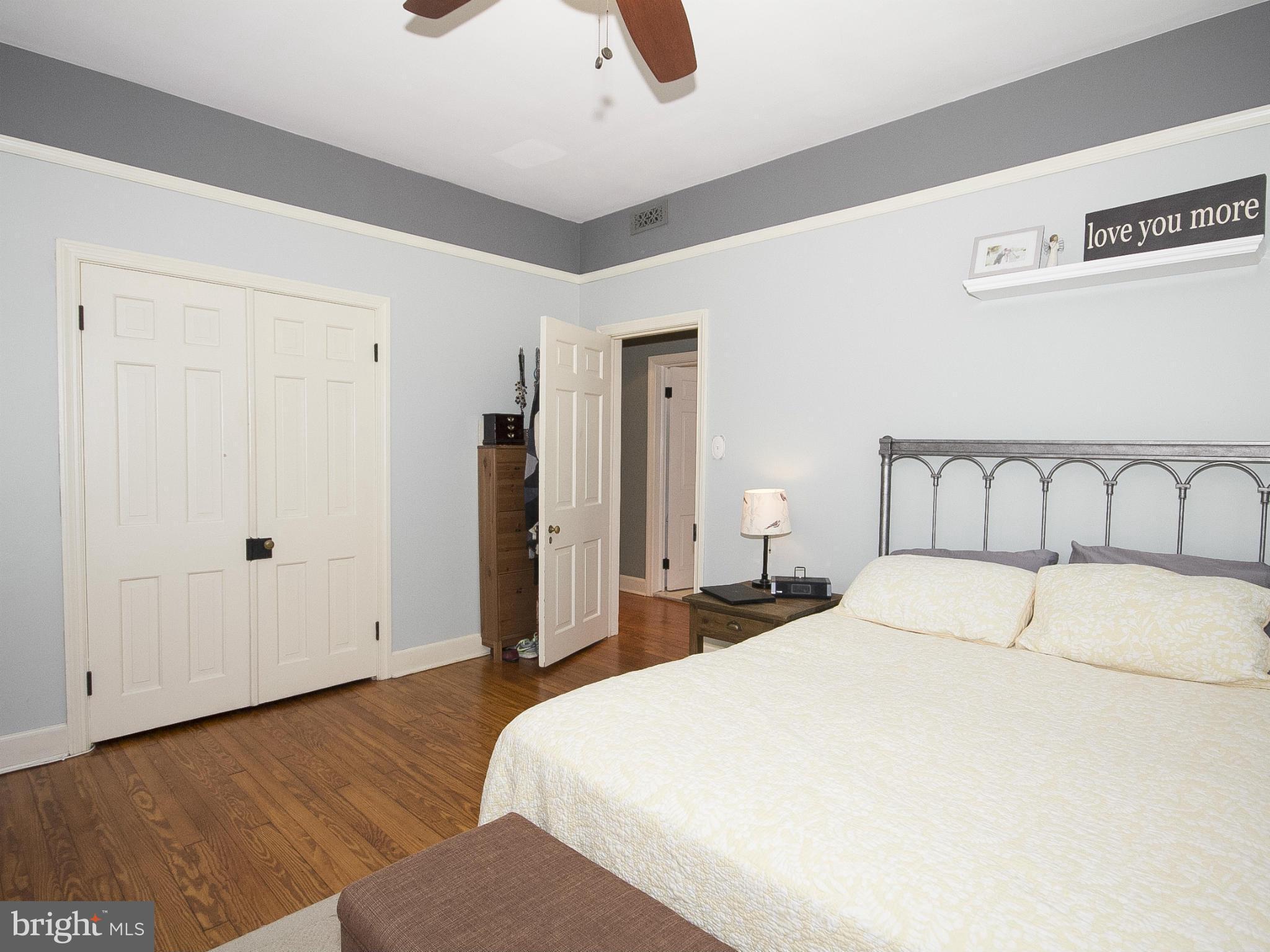 2539 Pickwick Road Baltimore, MD 21207 - Photo 26 of 30 a bedroom with a bed and wooden floor