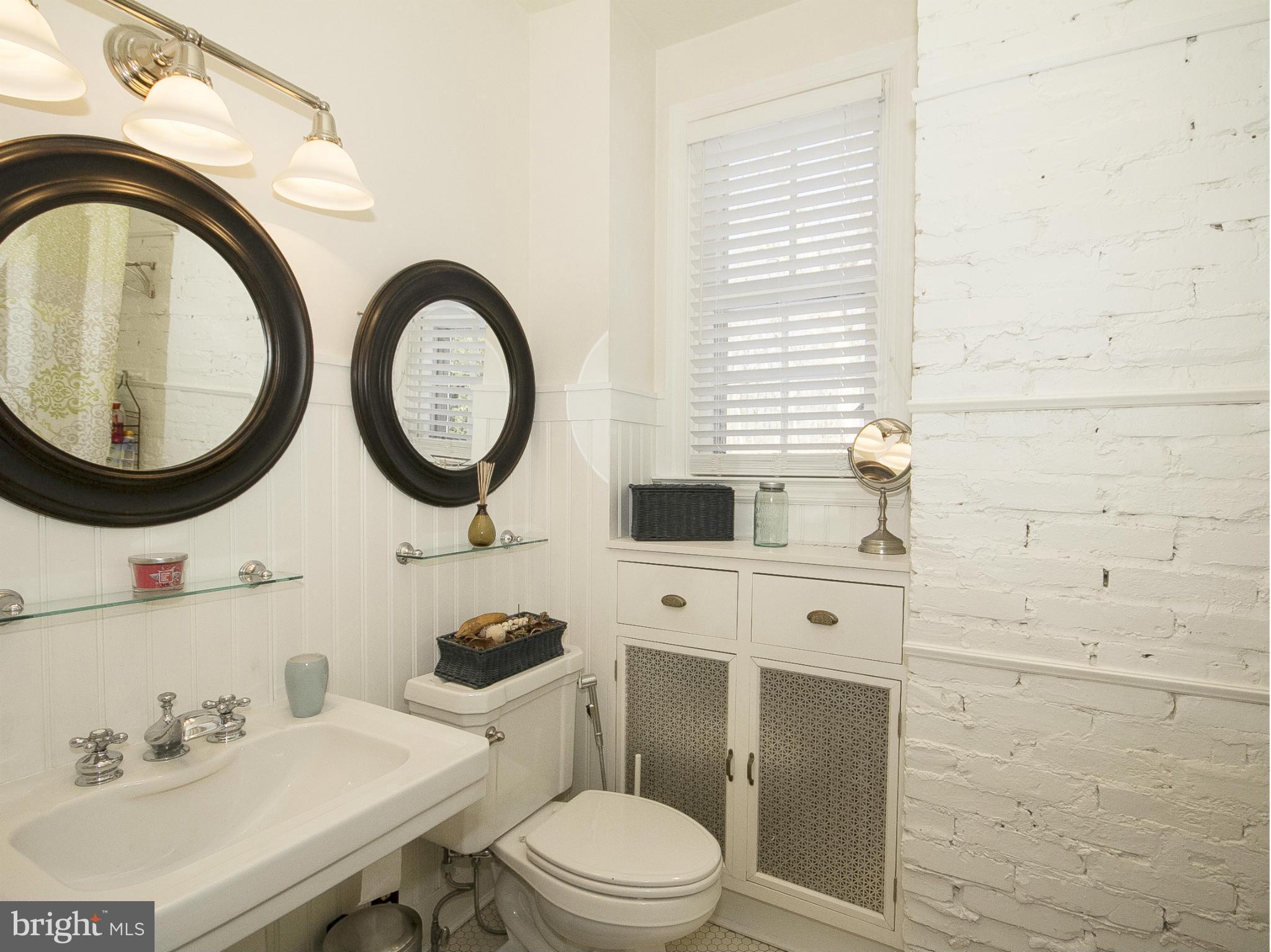 2539 Pickwick Road Baltimore, MD 21207 - Photo 27 of 30 a bathroom with a toilet a sink and a mirror