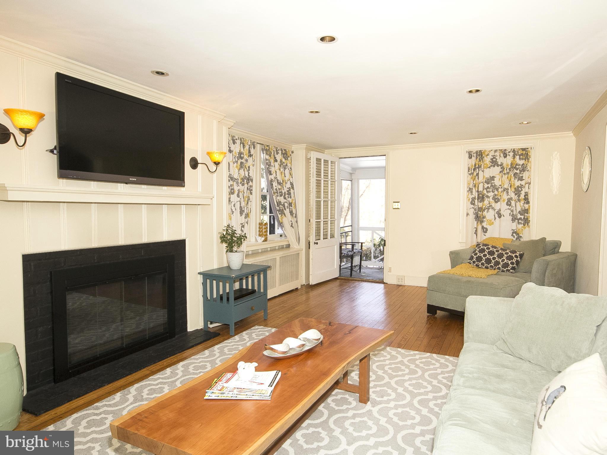 2539 Pickwick Road Baltimore, MD 21207 - Photo 6 of 30 a living room with furniture a flat screen tv and a fireplace