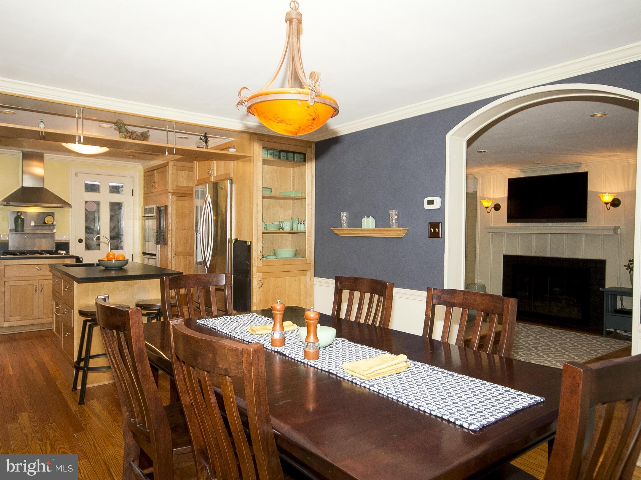 2539 Pickwick Road Baltimore, MD 21207 - Photo 8 of 30 a view of a dining room with furniture and a fireplace
