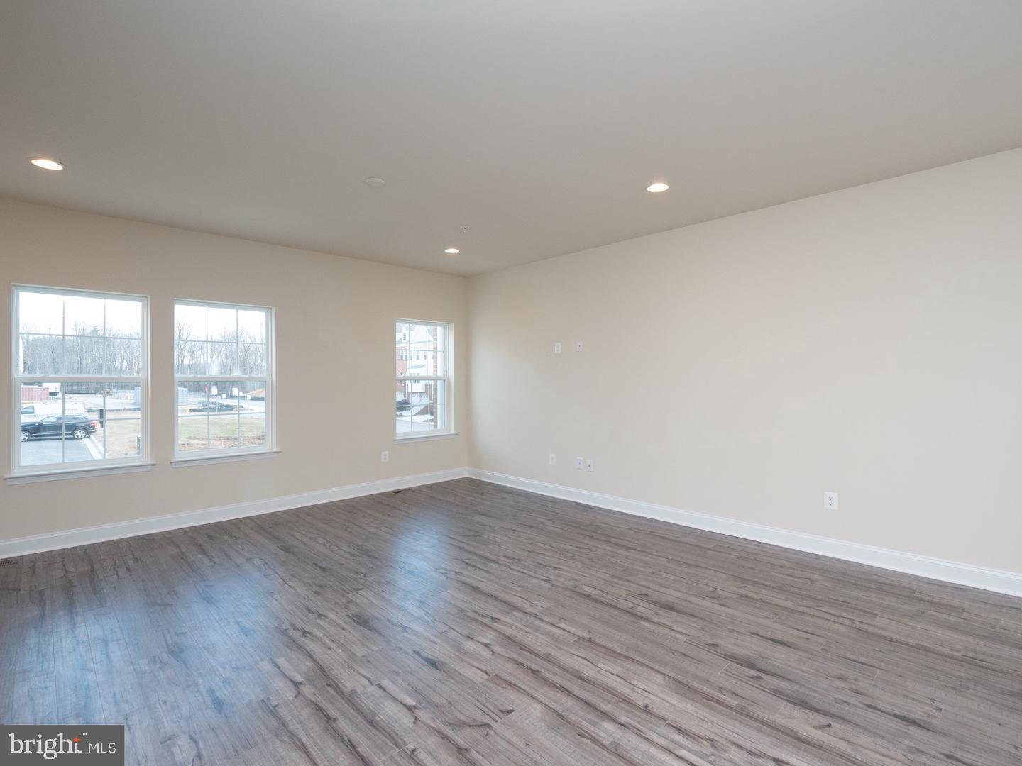 1016 Bluebells Road Gambrills, MD 21054 - Photo 12 of 52 a view of an empty room with wooden floor and a window