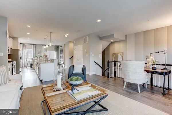 a living room with furniture and kitchen view