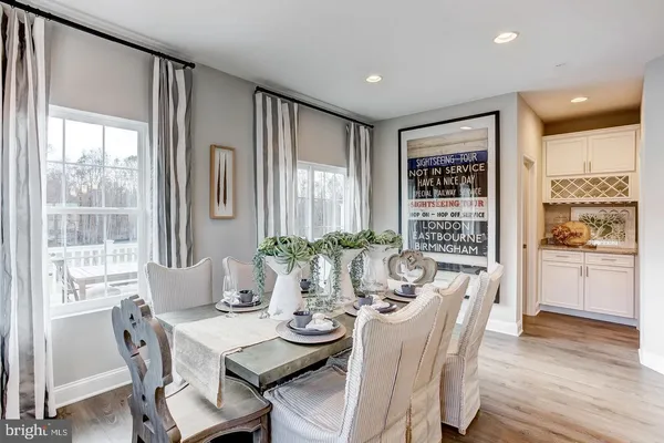 a view of a dining room with furniture window and wooden floor