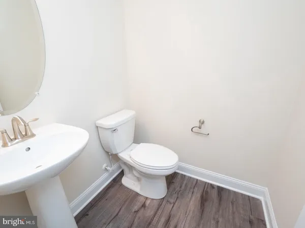 a white toilet sitting next to a white sink