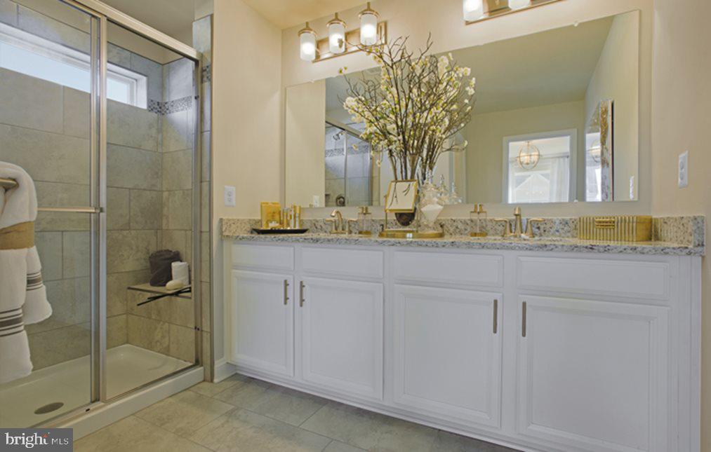 1016 Bluebells Road Gambrills, MD 21054 - Photo 29 of 52 a bathroom with a granite countertop sink a mirror and shower
