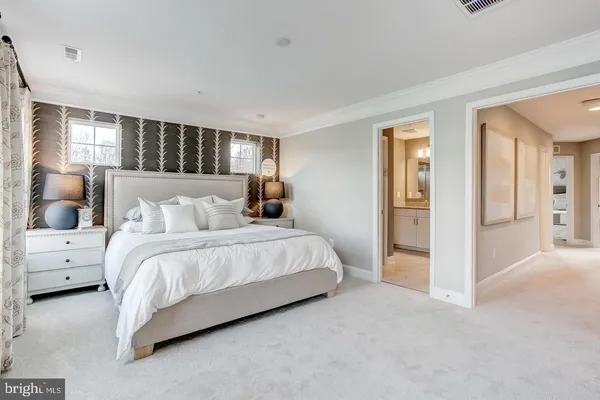 a spacious bedroom with a bed and a couch