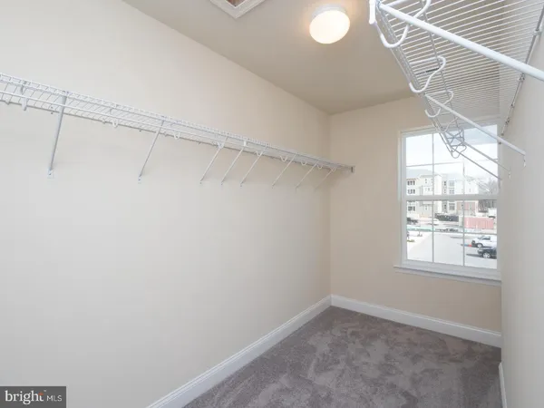 a view of a room with racks on the wall and a window