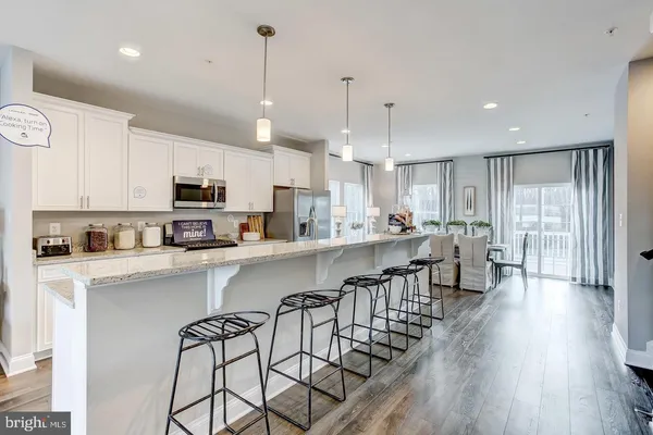 a large white kitchen with lots of counter space a sink and appliances