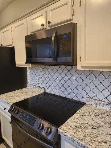 a kitchen with a stove and a microwave