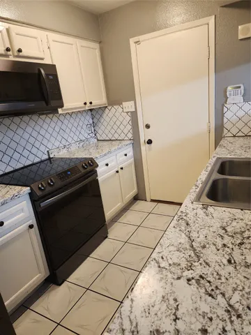 a view of an empty room with stairs