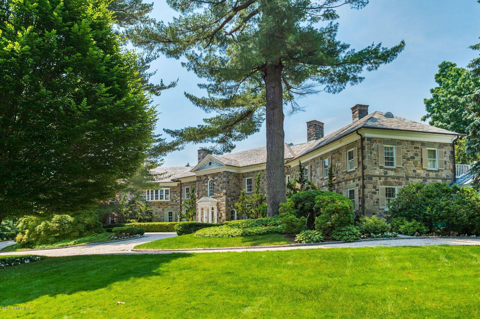 16 Rock Ridge Avenue Greenwich, CT 06831 - Photo 1 of 57 a front view of a house with a yard