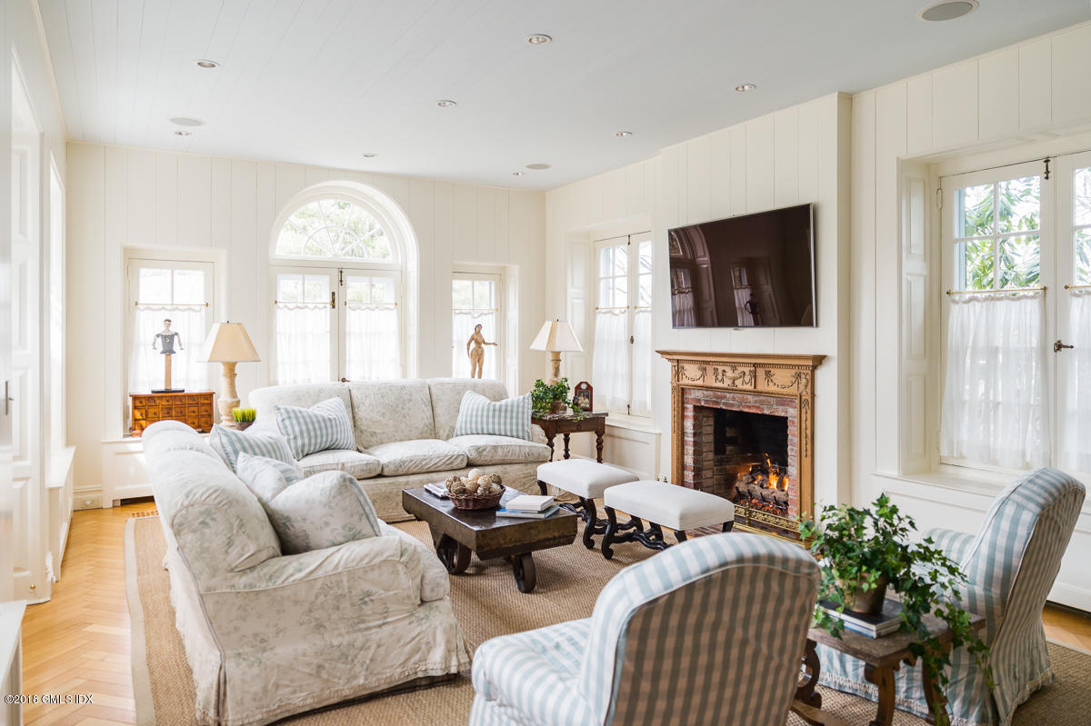 16 Rock Ridge Avenue Greenwich, CT 06831 - Photo 25 of 57 a living room with furniture fireplace and a flat screen tv