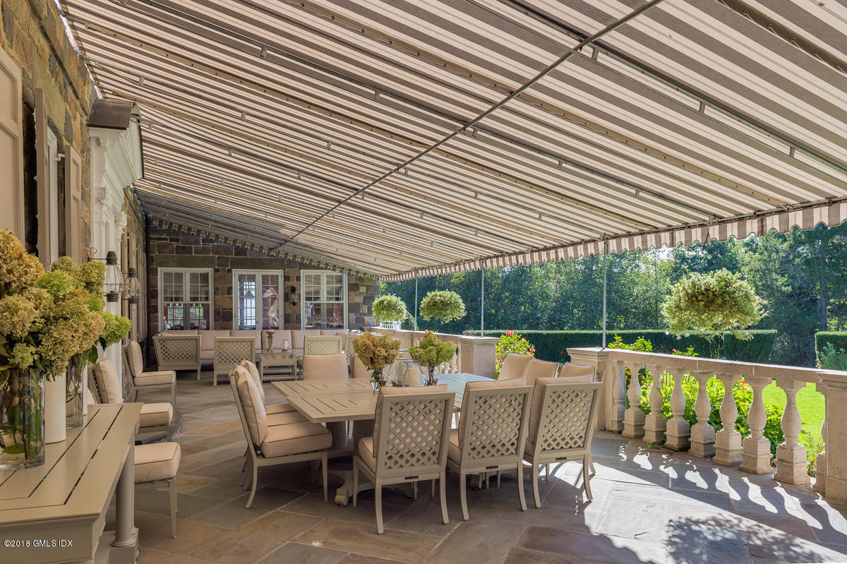 16 Rock Ridge Avenue Greenwich, CT 06831 - Photo 27 of 57 a view of a patio with a table chairs and backyard