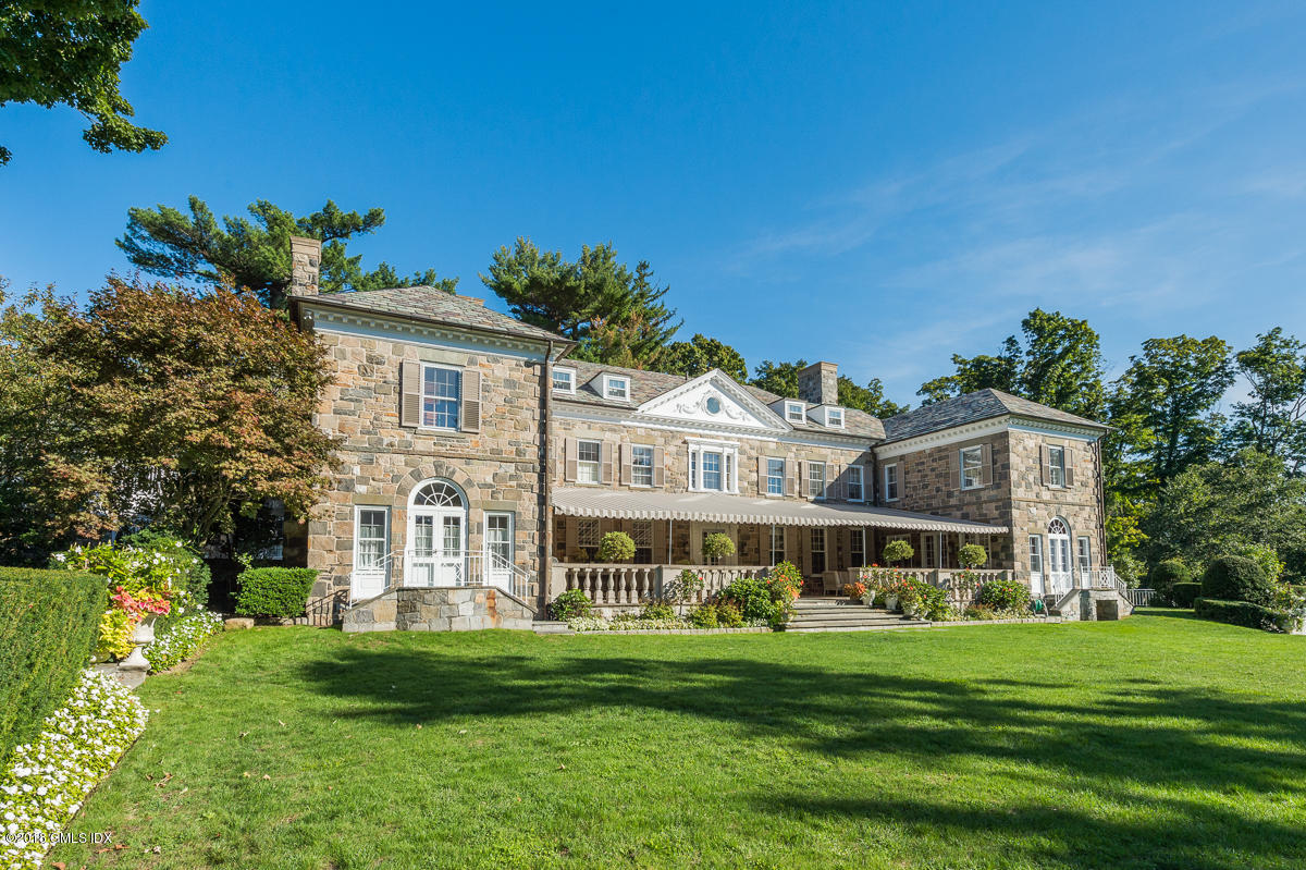 16 Rock Ridge Avenue Greenwich, CT 06831 - Photo 3 of 57 a front view of a house with a garden