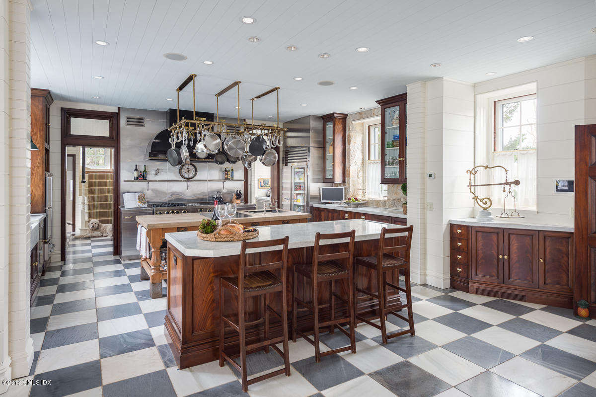 16 Rock Ridge Avenue Greenwich, CT 06831 - Photo 31 of 57 a kitchen with a dining table and chairs