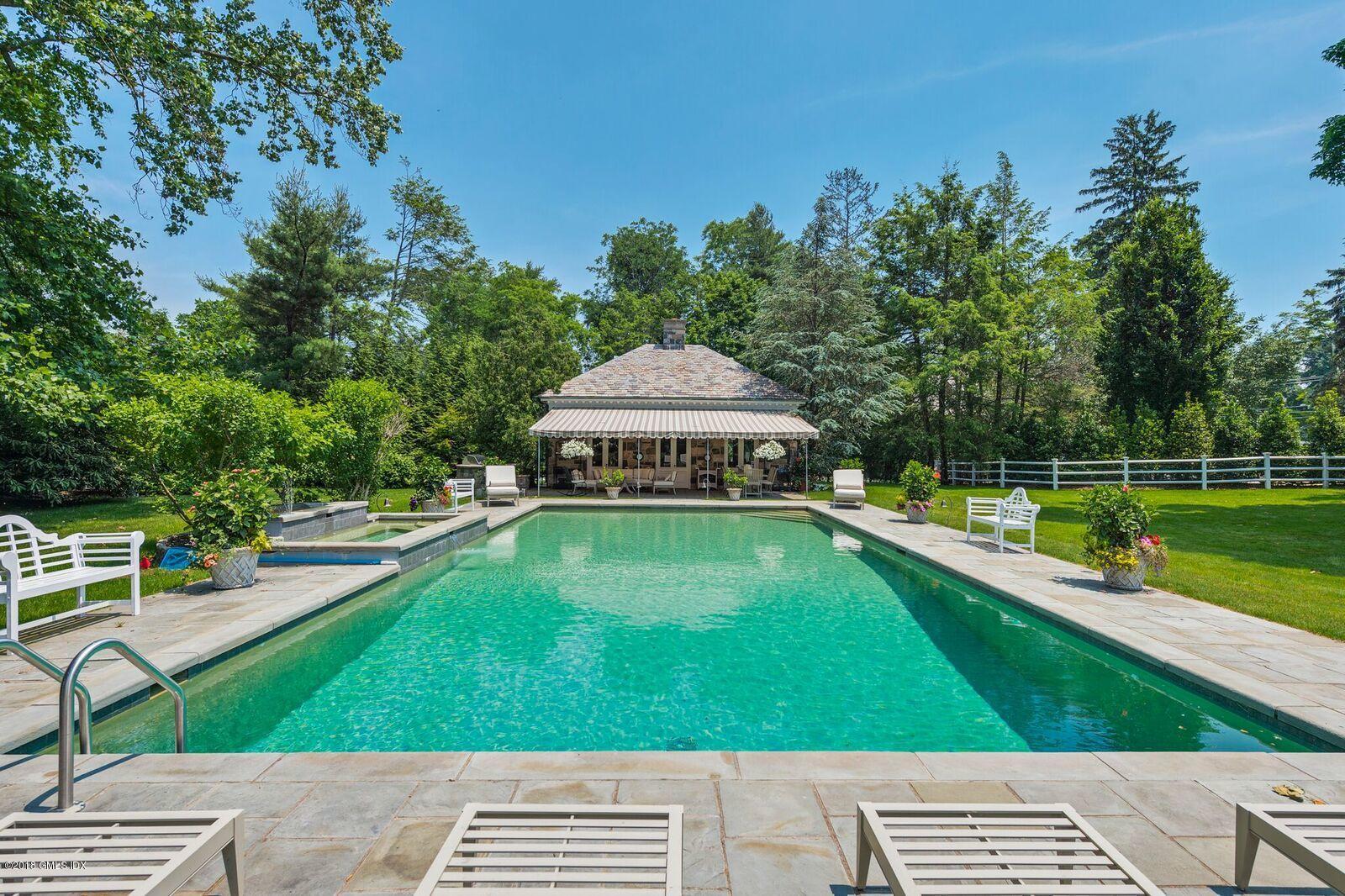 16 Rock Ridge Avenue Greenwich, CT 06831 - Photo 45 of 57 a view of a swimming pool with a garden and deck