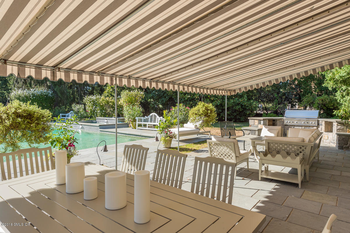 16 Rock Ridge Avenue Greenwich, CT 06831 - Photo 47 of 57 a view of a patio with a dining table and chairs with wooden floor