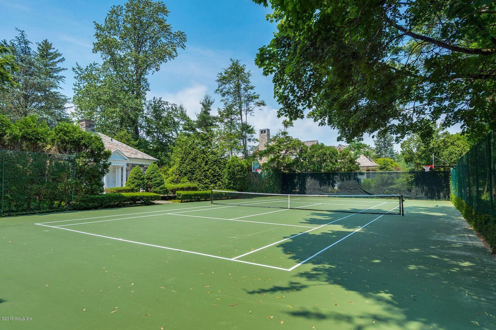 16 Rock Ridge Avenue Greenwich, CT 06831 - Photo 48 of 57 a view of a tennis ground with large trees